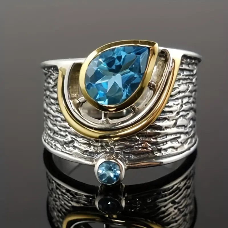 Silber- und Goldring mit blauen Kristallen